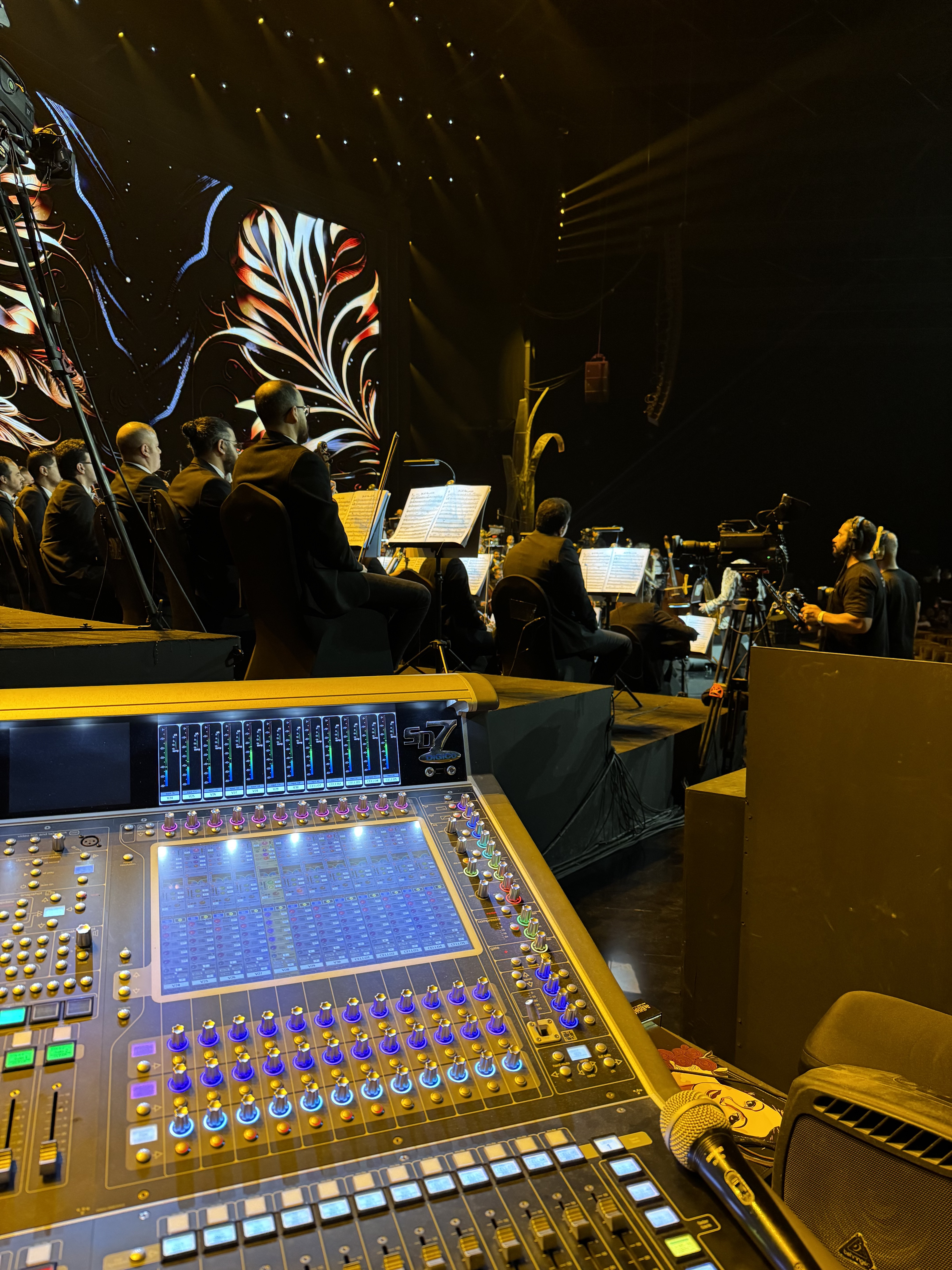 FOH desk with orchestra and ornate backdrop